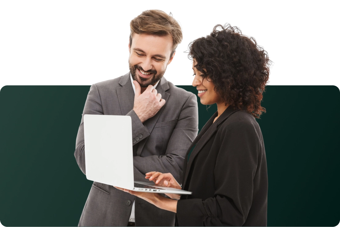 A man and woman looking at a laptop.